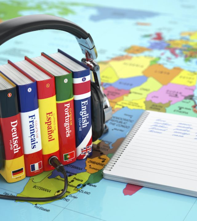 Learning languages online. Audiobooks concept. Books and headphones on the map world. 3d